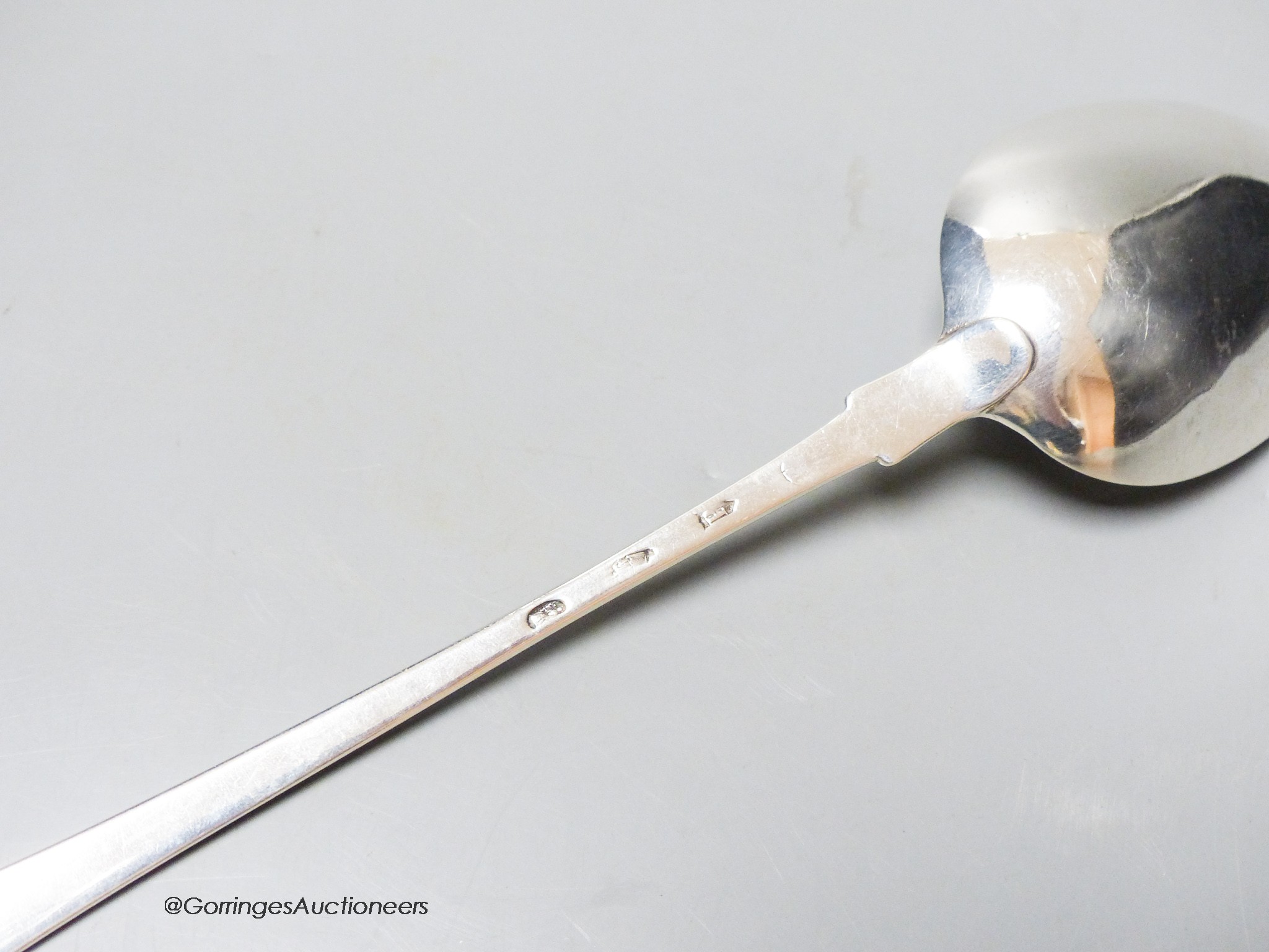 An early George III Irish silver fiddle pattern basting spoon, with strainer, Dublin, 1763, 33.9cm, 4oz.